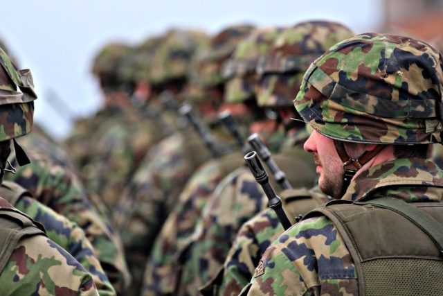 Wagner Chief Prigozhin, Lacking Official Rank, Led Powerful Private Force Yevgeny Prigozhin in military gear speaking to armed Wagner Group fighters in a field
