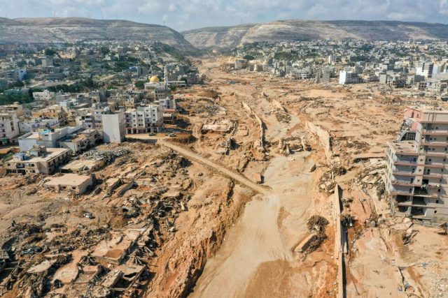 Derna Dam Collapse September 2023 Rescue workers search through rubble and debris in the flooded streets of Derna, Libya, after two dams collapsed following Storm Daniel.