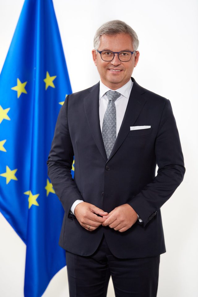 Directorate-General for Migration and Home Affairs European Commission building in Brussels with EU flags flying outside
