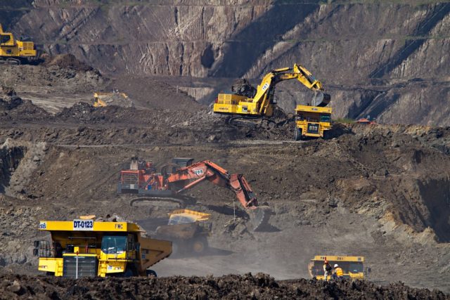 DRC supplies over 60% of global cobalt essential for electronics Artisanal miners dig red cobalt ore by hand in an open Congolese pit under a hazy sky.