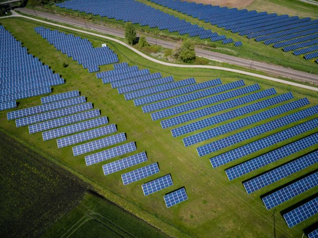China’s Solar Capacity Reaches One Terawatt, a Global First A vast field of solar panels stretches to the horizon under a bright sky, symbolizing China's record-breaking one terawatt solar capacity.