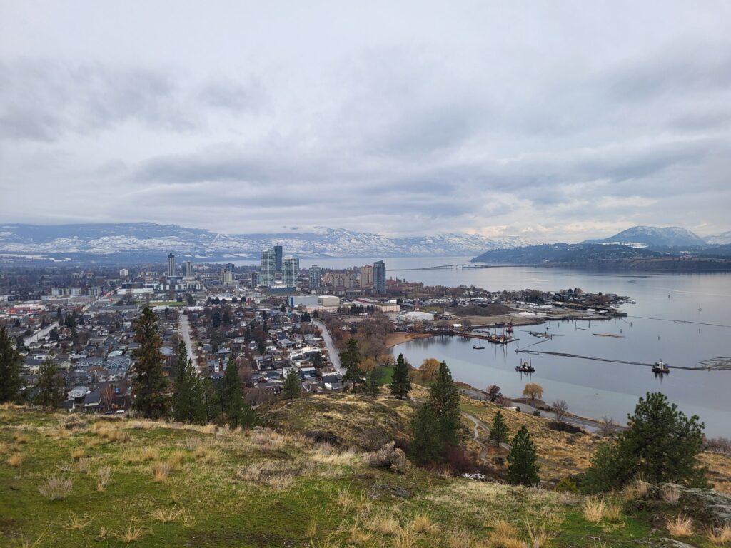 Smoke rising over Kelowna, British Columbia, as wildfires approach residential areas near Okanagan Lake.