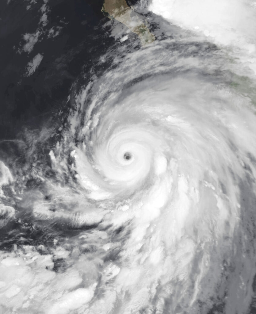 Satellite image shows swirling Category 4 Hurricane Hilary approaching Mexico’s Pacific coast with distinct eye and dense rain bands.