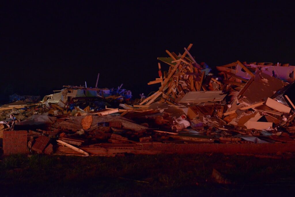 A collapsed campaign stage lies in ruins with debris scattered across the ground in San Pedro Garza Garcia after high winds caused the structure to buckle.