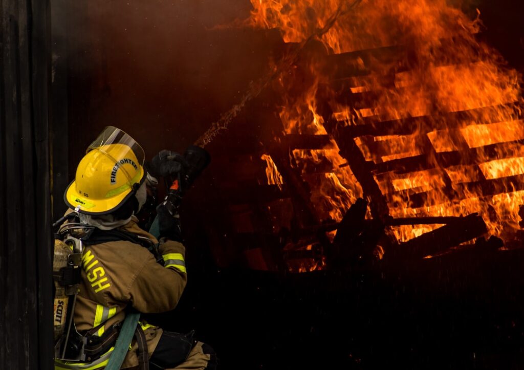 Firefighters and emergency vehicles at a burning apartment block in Mangaf, Kuwait, after a deadly fire killed 50 migrant workers.