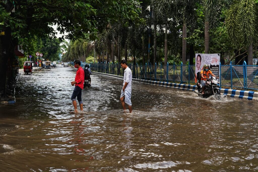 Floodwaters surround temporary shelters and damaged homes in a rural area of northeast India.
