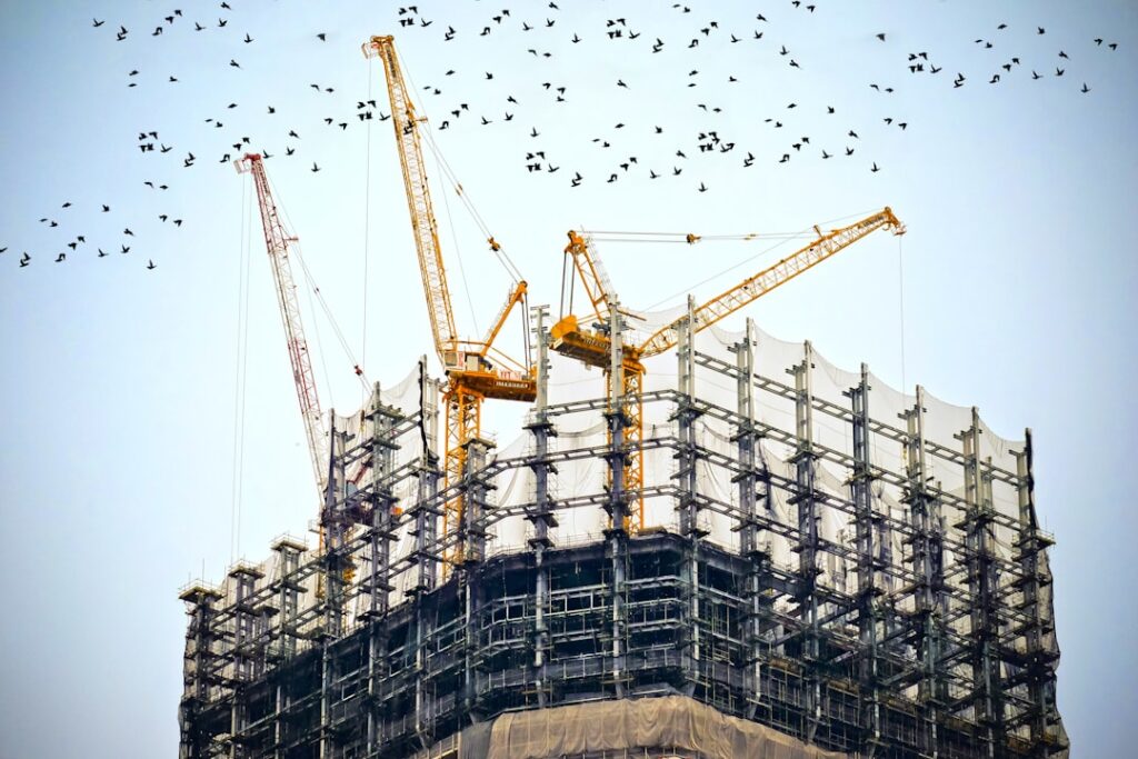 Rescue crews in hard hats dig through twisted steel and concrete debris at the site of a collapsed government skyscraper in Bangkok.