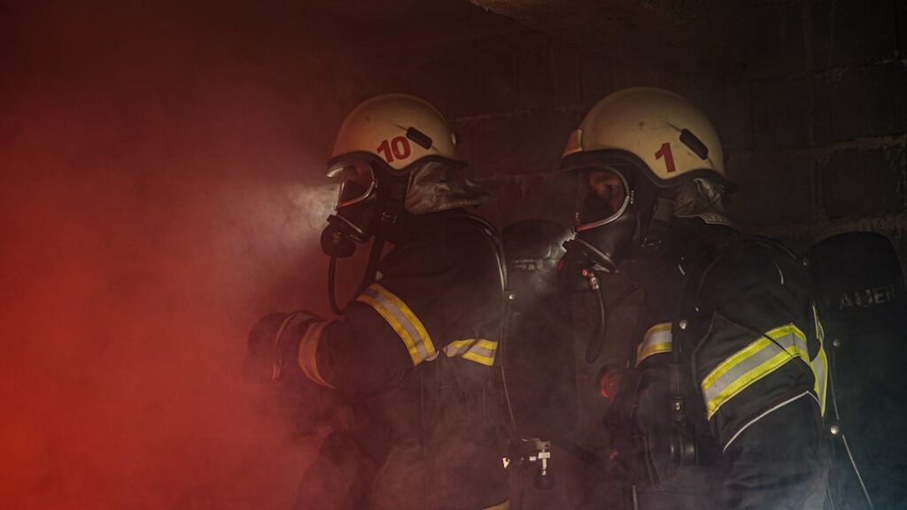 Firefighters battle flames and smoke pouring from a four-story apartment building in Milwaukee as residents flee the early morning blaze.