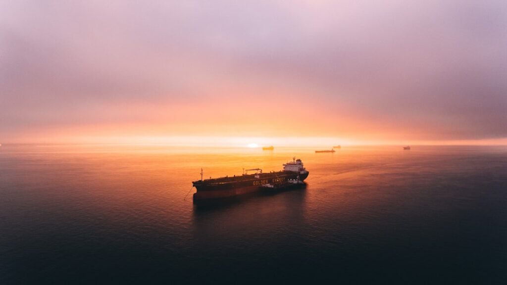 Aerial view of oil tankers navigating the narrow Strait of Hormuz under clear skies
