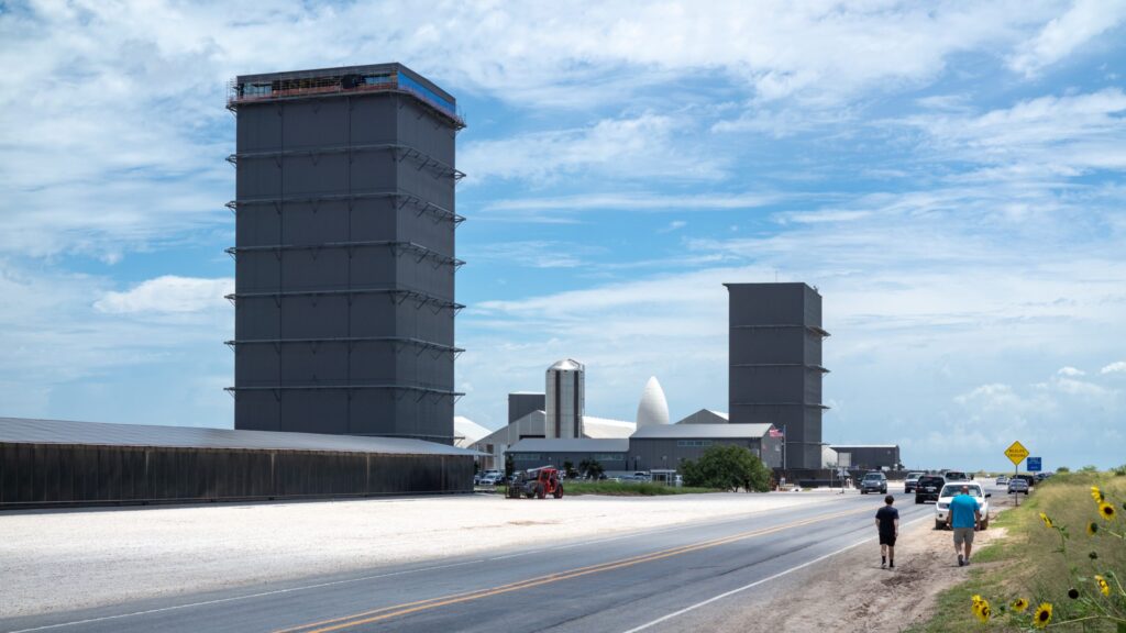 SpaceX Starship rocket booster caught by the arms of the launch tower at the Starbase facility in Texas during a test flight.