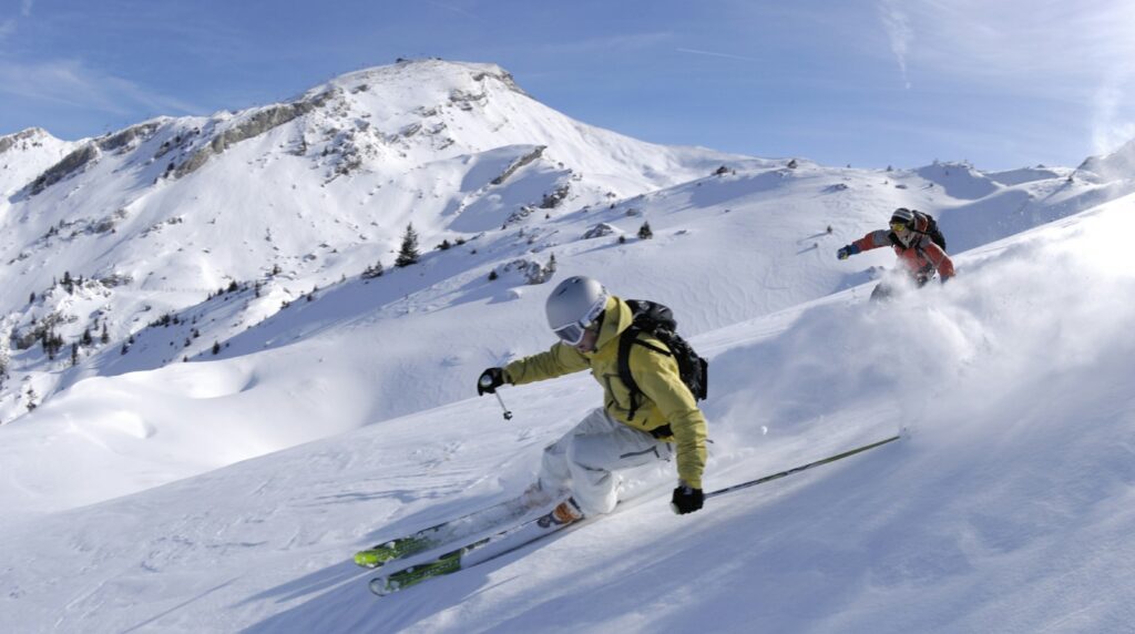 Rescue teams search a massive pile of snow in the Chugach Mountains after an avalanche trapped three skiers.