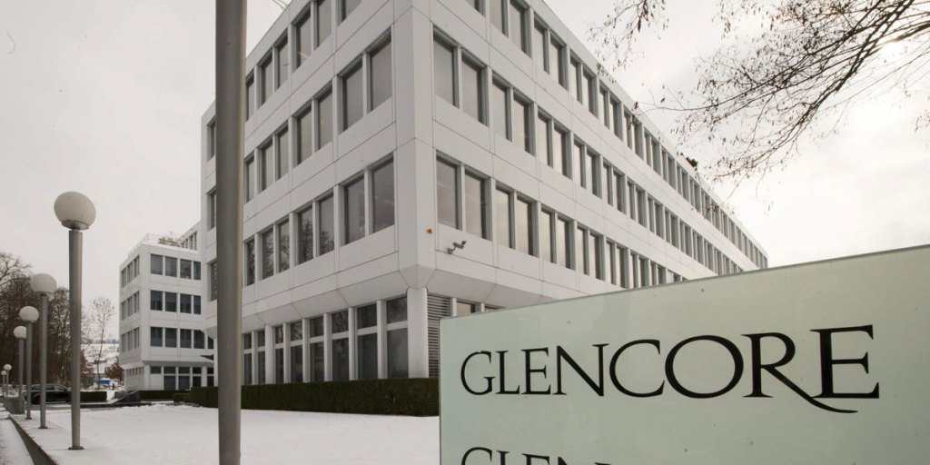 Glencore logo on a zinc smelter backdrop symbolizing its 60% grip on global zinc trade.