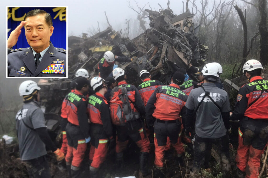 Rescue crews navigate muddy mountain terrain in northern Taipei searching for a downed Black Hawk helicopter carrying Taiwan's top general.