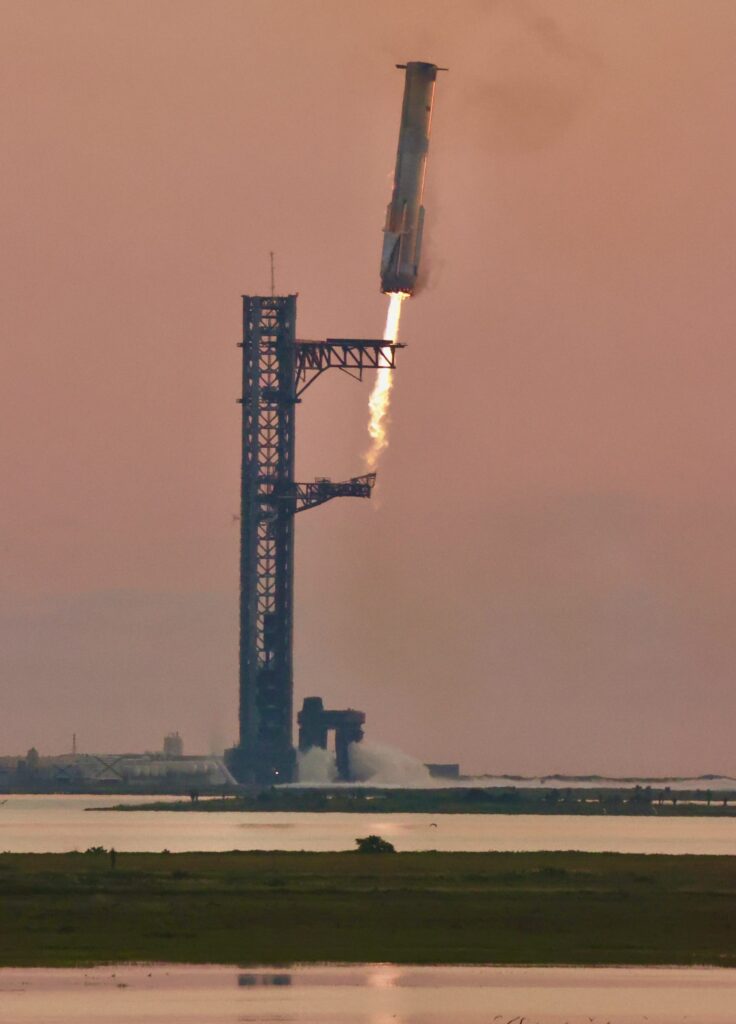 SpaceX Super Heavy Booster 12 caught by chopstick arms at the launch tower during Starship flight test 5